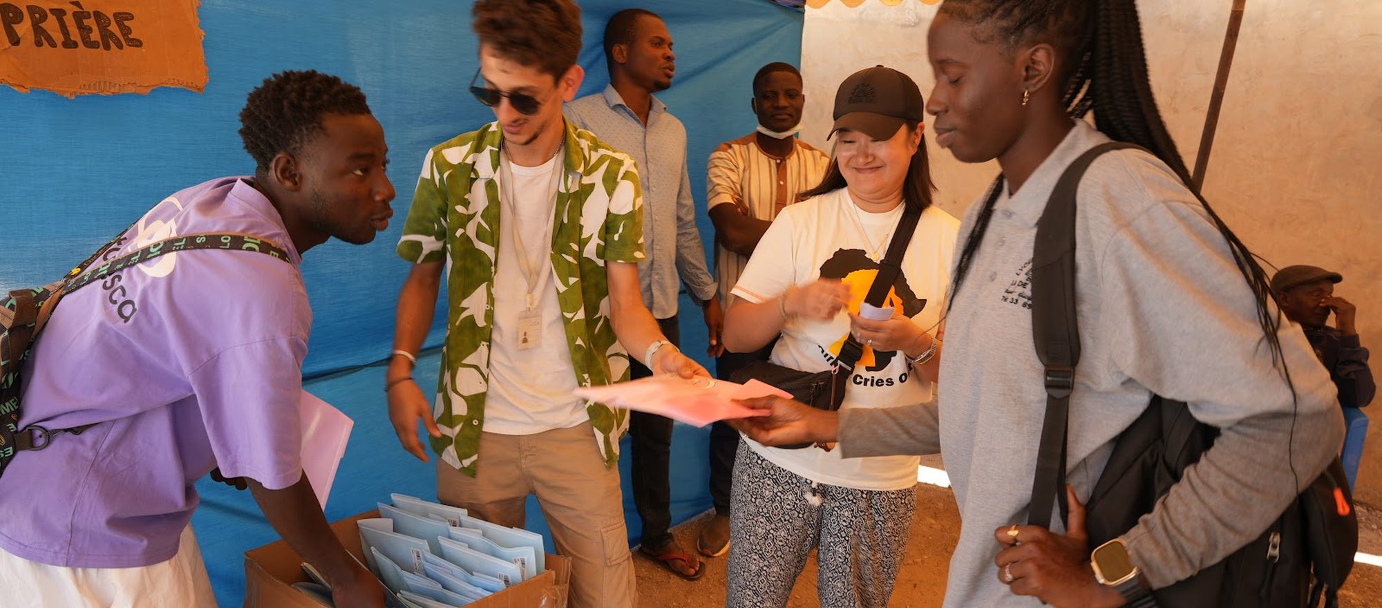 Young ACO volunteers serving side by side with local young people during a community outreach in Senegal