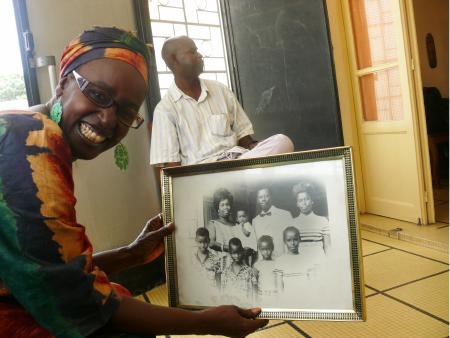 Figure 4: Dr. Faye’s sister Fatimo holding the old photograph of Dr. Faye’s family: the man wearing a bow tie was Professor Faye, Dr. Faye’s father.