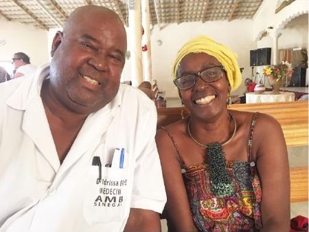 Figure 6: Dr. Faye and his sister Fatimo. The AMB above Faye’s work clothes is the abbreviation for Association of Medical Bushes, an acronym for the Association of the Doctors of the Jungle. This photo was taken one day before Faye and Dr. Xu went to leprosy village. His sister was also a graduate of University of Dakar and is currently involved in the campaign for the rights of women and children. She used to work at the U.S. Embassy in Senegal. She is fluent in English and she translated it for Dr. Xu.