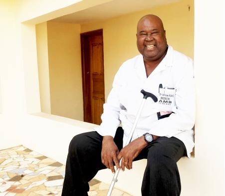 Figure 9: Dr. Faye, smiling with a cane in hand.