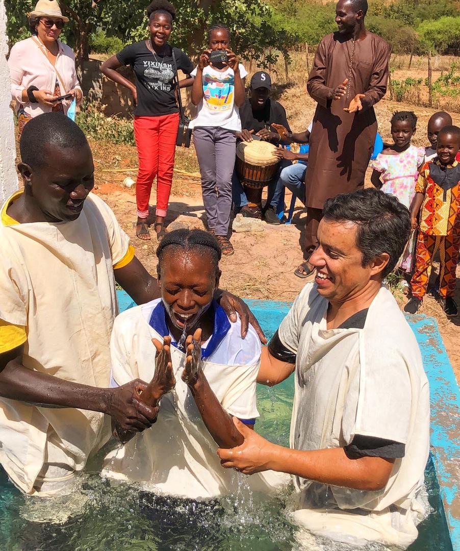 Fig 5. Pastor Anderson baptizes Christians at the base.