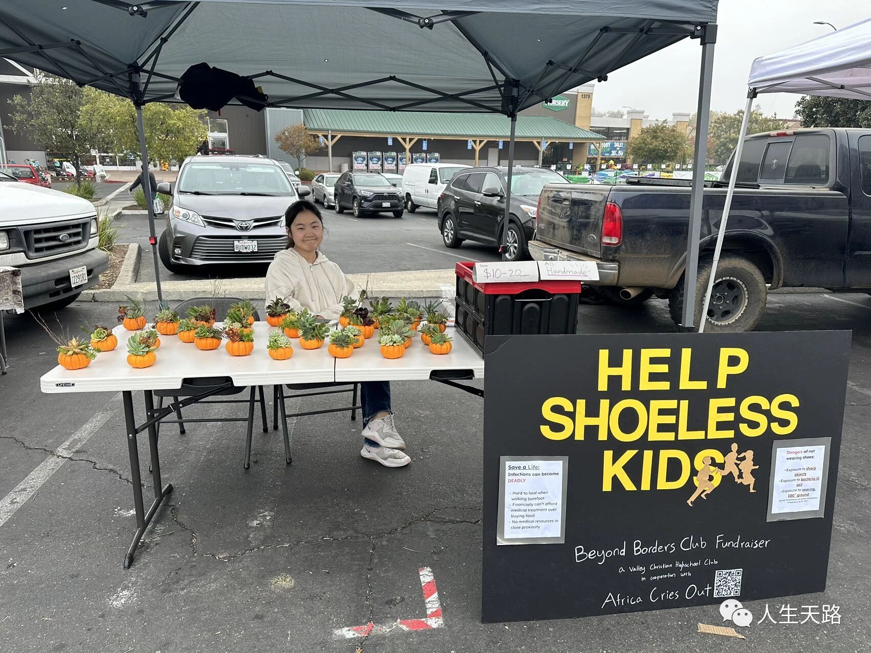 A student at a farmers' market booth with a Help Shoeless Kids poster