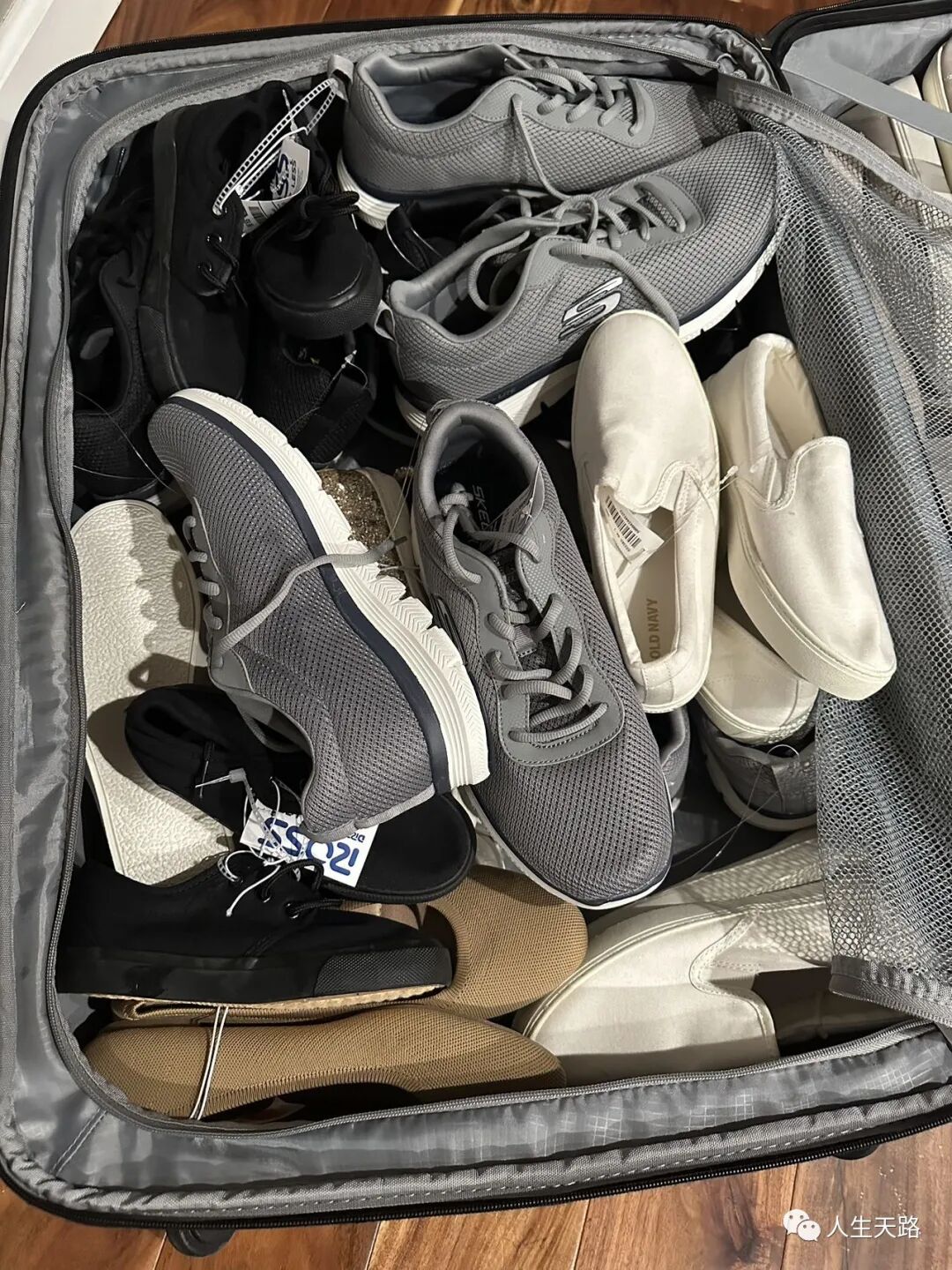 A suitcase packed full of new shoes with tags, bound for Senegal